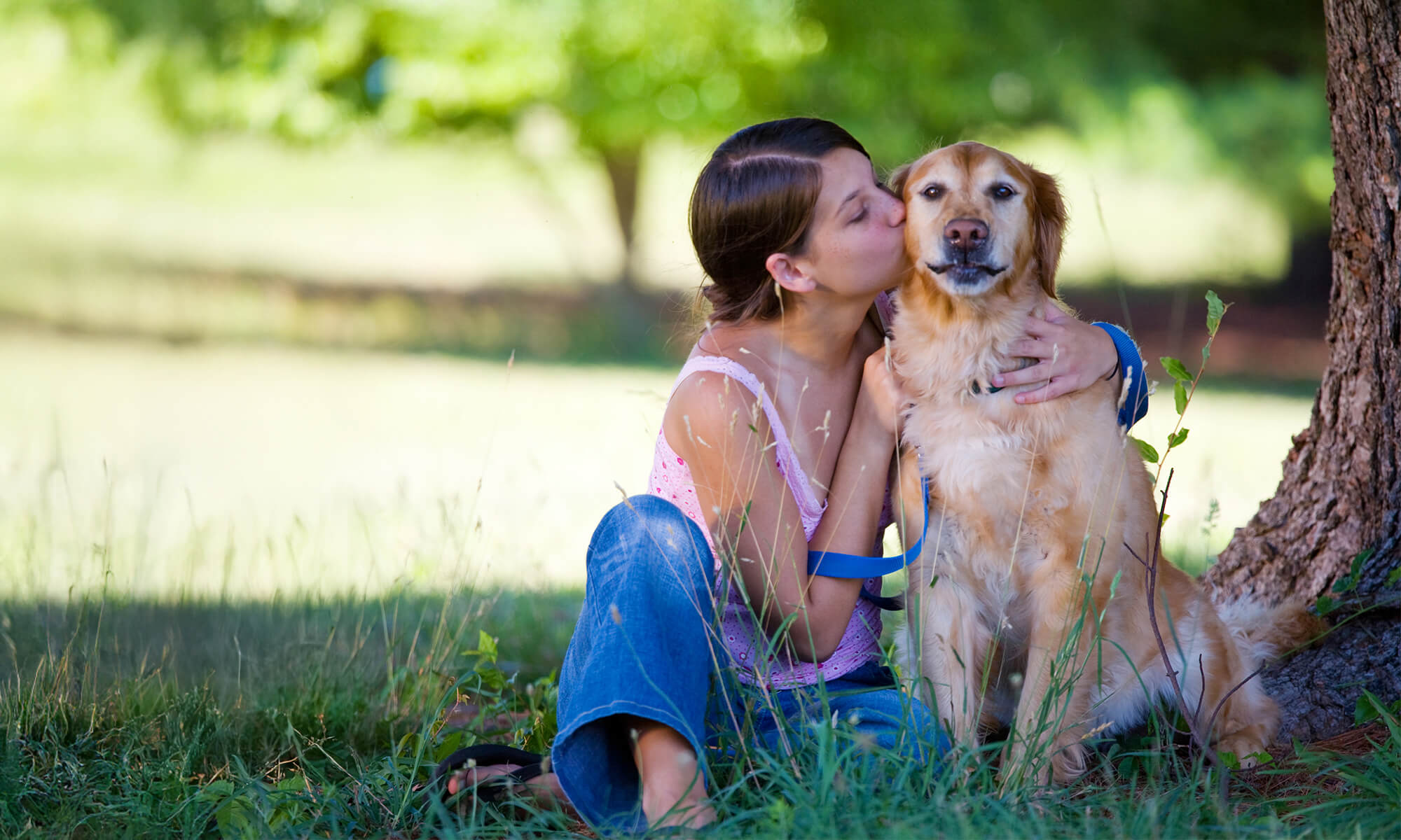 Woman kissing her dog